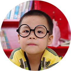 Kid with glasses looking at the camera